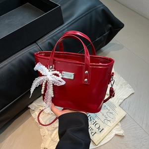 Red patent leather bucket bag with white lace bow and pearl charm for 2025 summer