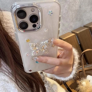 Detail of luxury pearl white iPhone case with 3D diamond butterfly and crystal lanyard