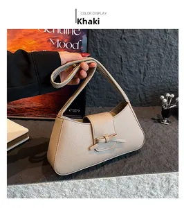 Detail of khaki pebbled leather shoulder bag with a 3D decorative bow and wide strap