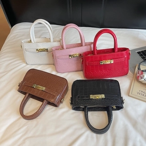 Croc-effect top handle bags in five colors featuring gold metal twist-lock closure