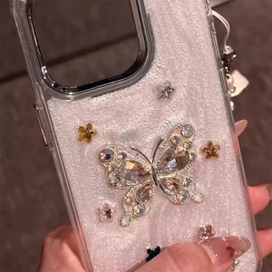Detailed close-up of iPhone case featuring a 3D rhinestone butterfly with glitter finish
