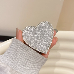 Detail of silver heart phone socket grip with sparkling rhinestones and crystal border