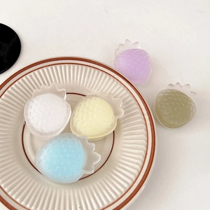Macro shot of strawberry shaped resin phone grips in various pastel matte colors