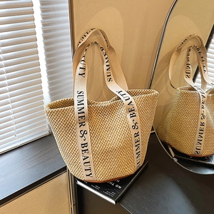 Large beige woven straw tote bag with Summer & Beauty lettered handles for beach use