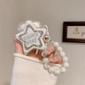 Detailed close-up of a star-shaped earphone case with a shiny star and pearl bracelet