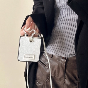 Close-up of white lychee leather phone wallet with silver metal frame and cloud hook