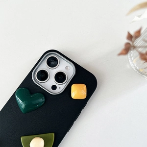 Detail of black leather iPhone case with colorful 3D geometric heart resin shapes
