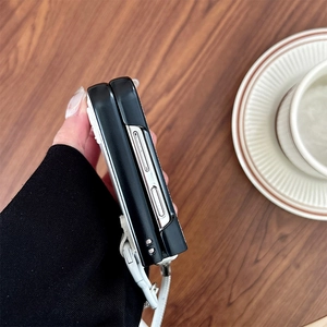 Side view of black leather folding phone case with white braided strap for Samsung Z Flip