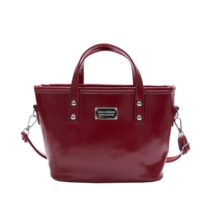 Deep red patent leather bucket bag with silver hardware and detachable strap