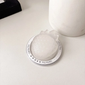 Macro detail of a translucent strawberry-shaped phone grip with Gift For You base