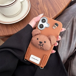 Close-up of iPhone case featuring a 3D plush bear and coffee cup with leather texture