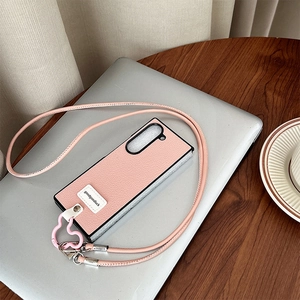 Pink leather crossbody phone case for foldable screens with heart charm and long strap