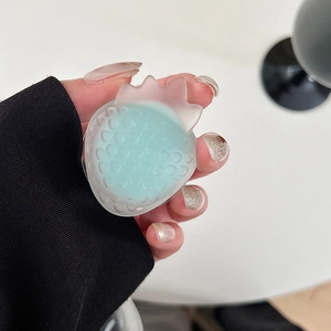 Macro detail of translucent blue strawberry phone grip with a frosted silicone texture