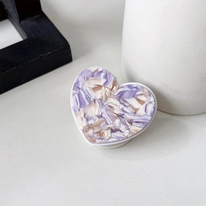 Detailed top view of a heart-shaped phone socket with purple marble texture on a white base