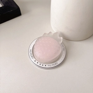 Macro detail of strawberry-shaped phone grip with Gift For You acrylic base