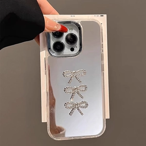 Silver mirror iPhone case with rhinestone bowknots and a stylish handheld chain strap