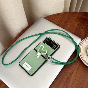 Pale green leather folding phone case with crossbody strap and bear hook detail