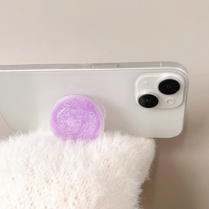 Sparkly purple round collapsible phone grip socket with fine glitter finish on white phone
