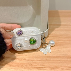 Detail of AirPods Pro case featuring colorful rhinestones, pearls and butterfly pendant