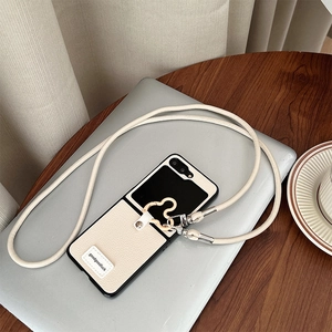 Detail of lychee leather folding phone case with crossbody strap and metal ring buckle