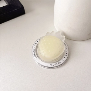 Detail of strawberry-shaped phone socket grip with translucent matte yellow finish