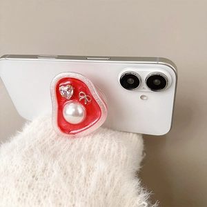 Retro rhinestone pearl heart phone grip stand on a white smartphone back