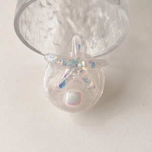 Detail of glitter starfish phone grip with iridescent sequins and mother of pearl