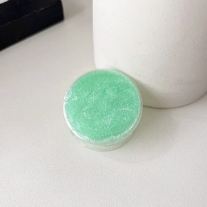 Detail of mint green glitter phone grip holder with sparkling pearl shimmer effect