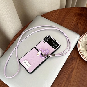 Detail of lavender litchi leather phone case with cross-body strap and floral ring buckle