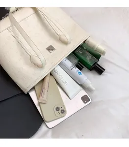 Grand sac fourre-tout blanc montrant sa capacité pour iPad, téléphone et cosmétiques