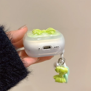 Detailed macro view of AirPods Pro case with glitter finish, 3D bow, and pearl charm