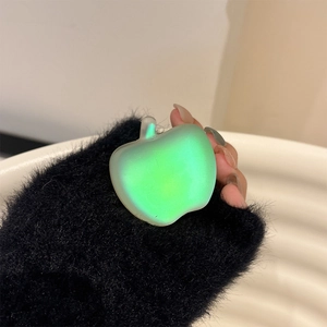 Close-up of translucent iridescent apple phone grip with vibrant green color gradient