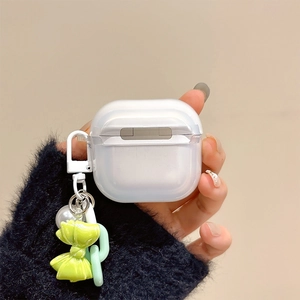 Detail of translucent frosted AirPods case with a green bow pendant and chain