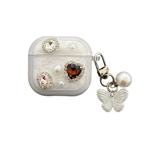 AirPods case with rhinestone heart, pearls and butterfly charm in milky white finish