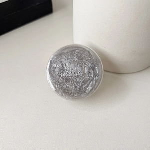 Macro shot of silver glitter round phone socket with reflective textured metallic finish