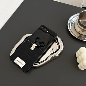 Detail of black leather phone case with card slot and Mickey silhouette ring holder