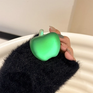 Close-up of green apple phone grip with matte texture being held in a hand