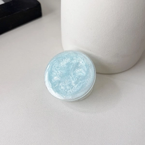 Detail shot of light blue glitter resin phone grip showing starry shimmer texture