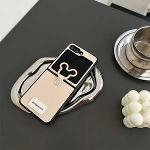Detail of leather crossbody case with a Mickey-shaped ring holder on metal tray