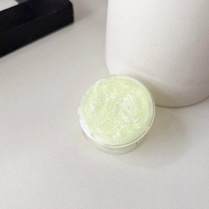 Macro shot of light green glitter phone grip with fine shimmering texture and round shape