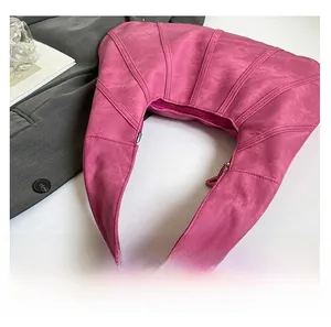 Macro shot of rose pink crescent bag showing fine matte leather and radial quilting texture