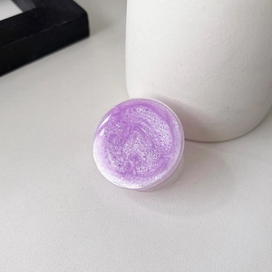 Macro detail of lavender glitter resin surface on a round phone grip stand accessory