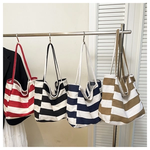 Detailed view of striped canvas tote bags in four colors showing large capacity design