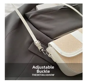 Detail of adjustable silver buckle on beige woven saddle bag with white leather trim