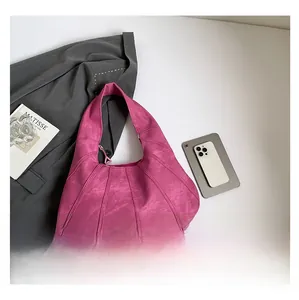 Detailed capacity view of rose red tote bag shown next to a smartphone and tablet