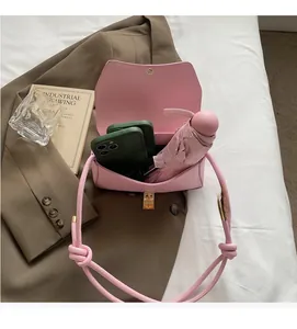 Interior view of pink baguette bag showing capacity for umbrella and smartphones