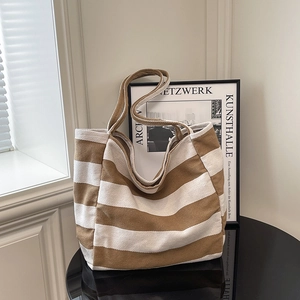 Minimalist canvas tote bag featuring classic brown and white stripes for daily commute