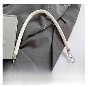 Close-up of white padded leather handle with polished silver metal chain and ring detail
