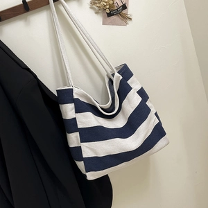 Striped canvas tote bag in navy and white with long handles for casual daily use