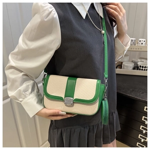 Detail of crossbody bag in green and white weave texture with mini round coin purse